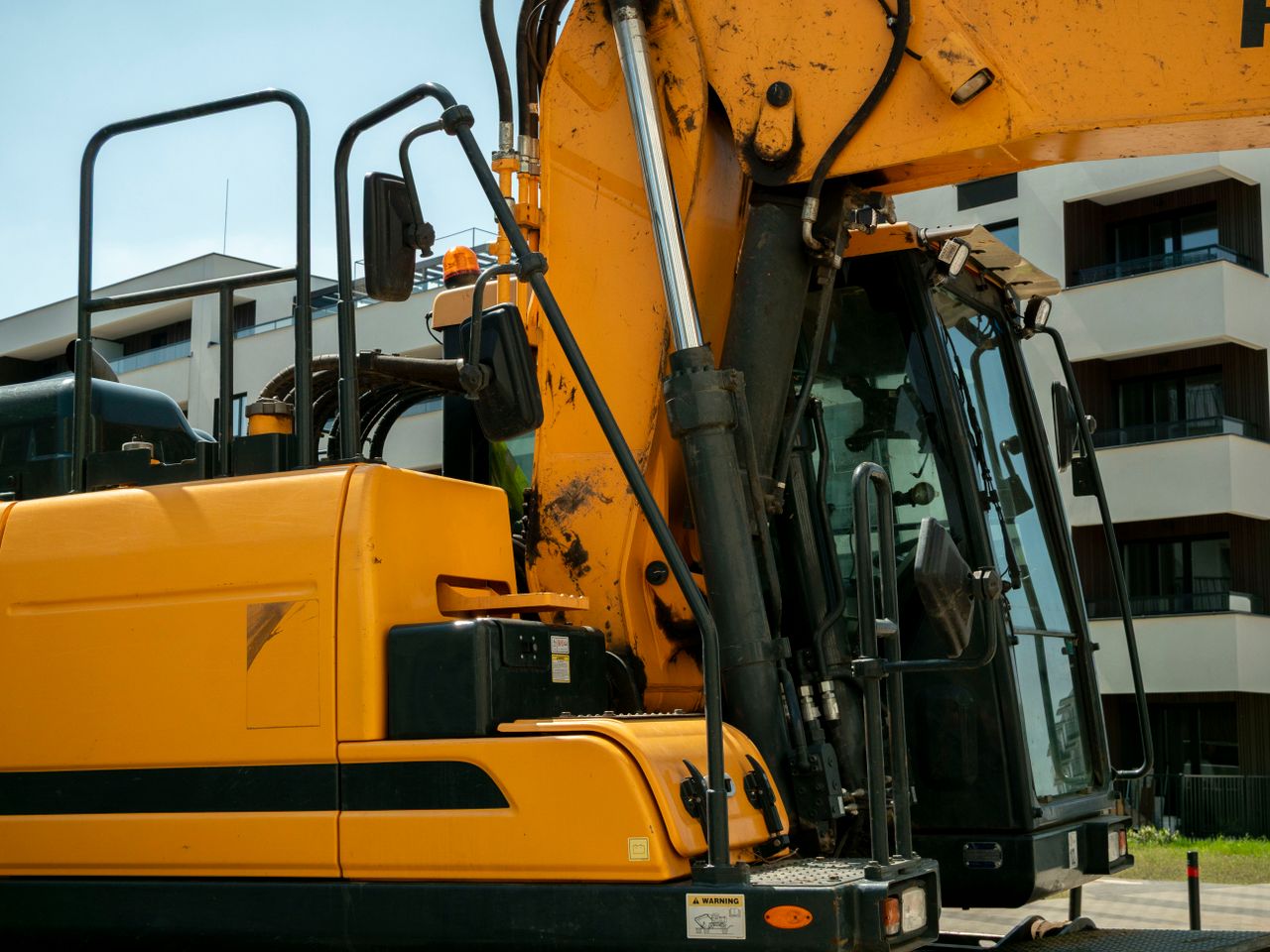 Close-up of a yellow excavator in an urban construction site in Wrocław, Poland.